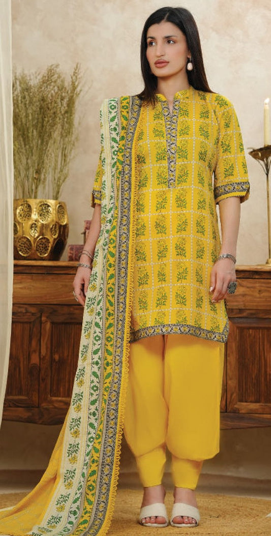 A woman wearing a yellow and green floral printed lawn suit with a dupatta.