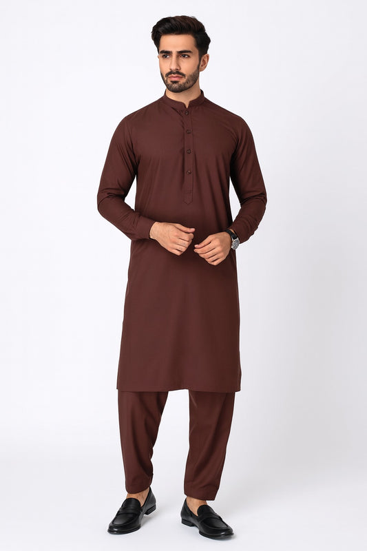 Man wearing a brown traditional outfit on a white background