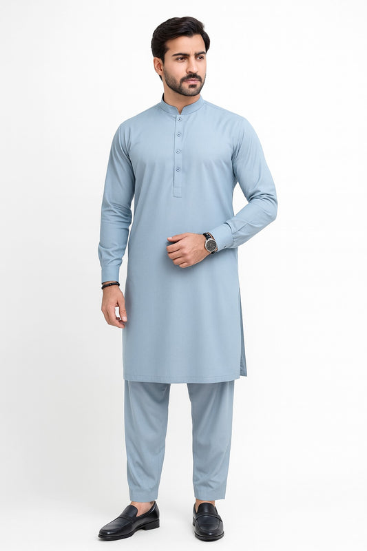Man wearing a light blue kurta with trouser on a white background