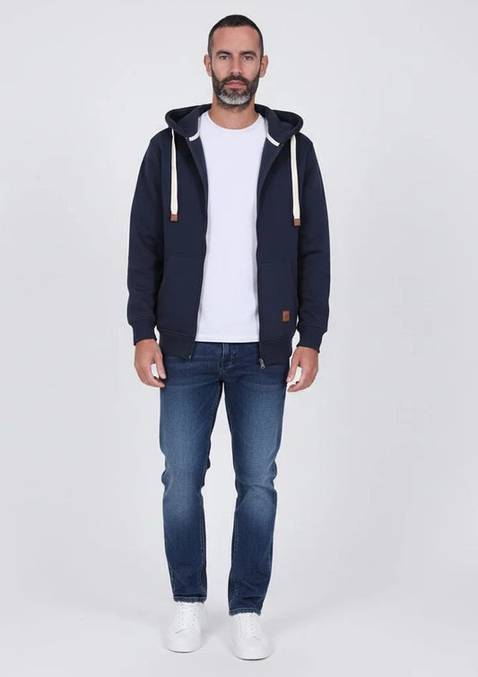 Man wearing a navy hoodie, white t-shirt, and blue jeans on a white background