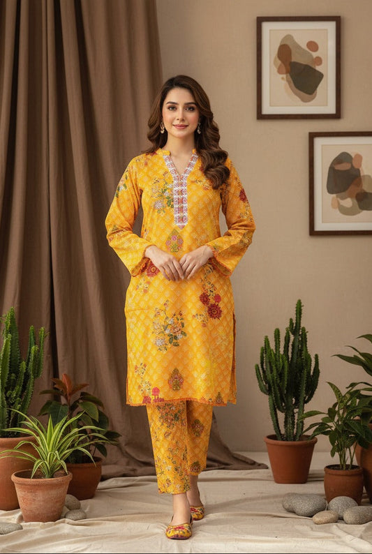 Woman in a yellow traditional outfit standing in a room with plants and decor.
