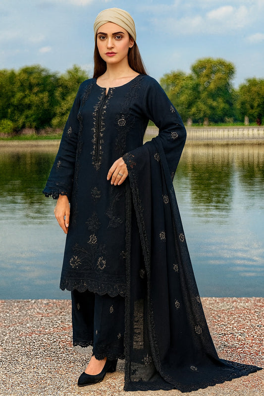 Woman in a navy traditional outfit standing by a lake with trees in the background