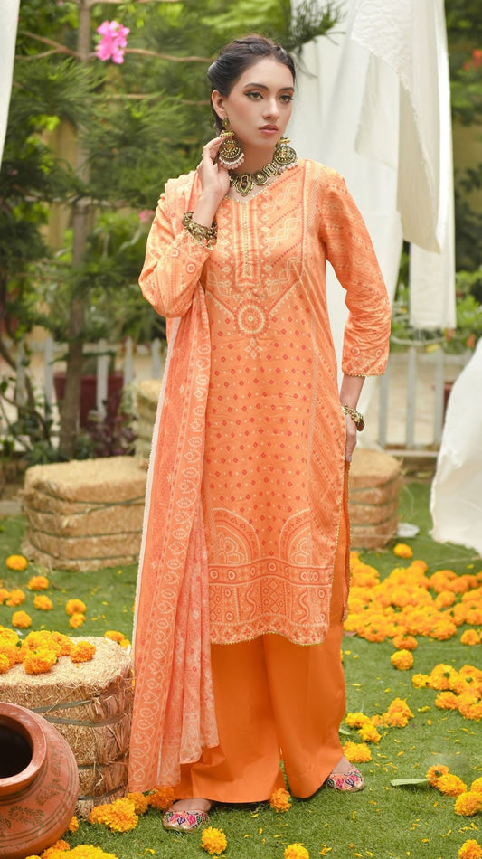 Woman in an orange traditional outfit standing outdoors with flowers and greenery around.