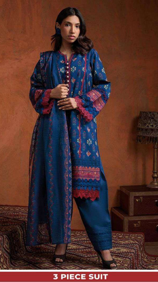 Woman wearing a bonanza blue printed suit with a brown background