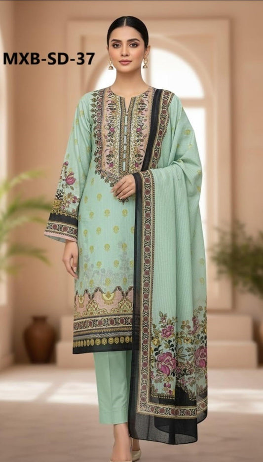 Woman wearing a light green traditional outfit with floral embroidery in a neutral setting