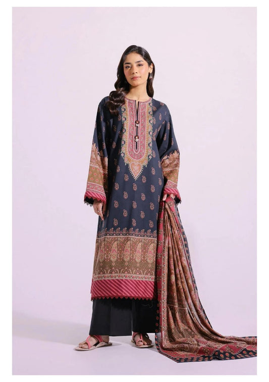 Woman wearing a printed traditional outfit with a dark blue top and black pants, holding a matching dupatta.