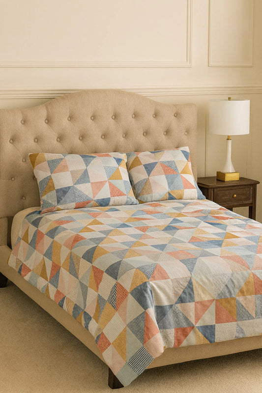 Bed with geometric patterned bedding in a bedroom setting