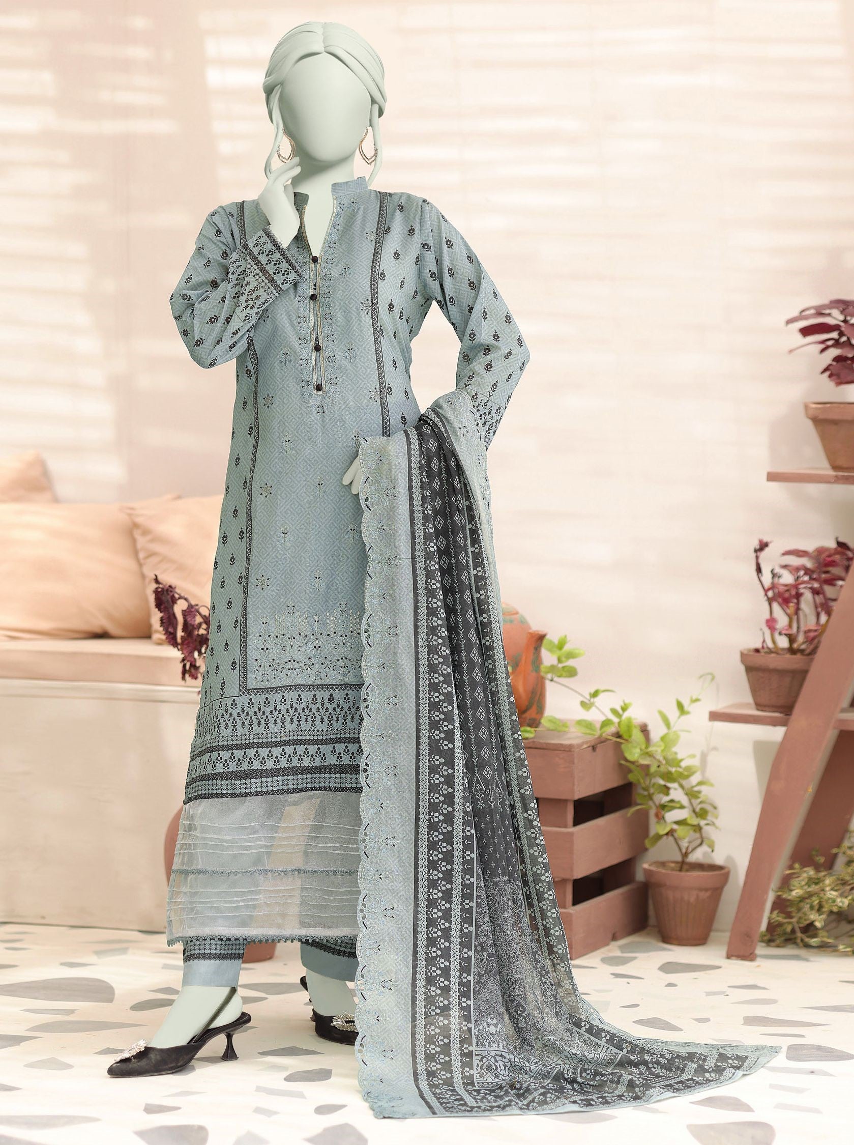 Mannequin wearing a light blue embroidered dress with a matching dupatta in a home setting.