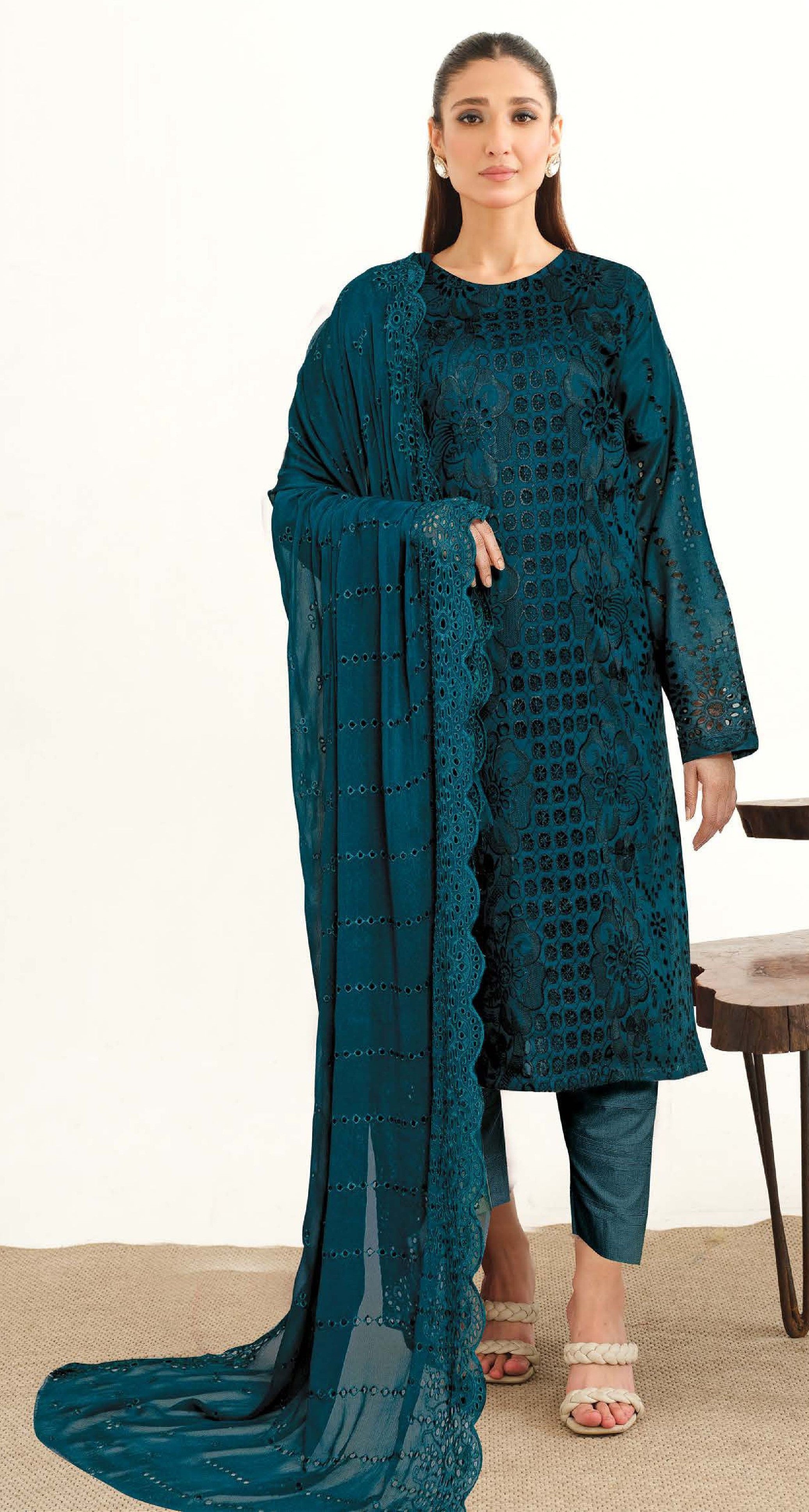 A woman wearing a green floral and paisley Chikankari Lawn 3 Piece Suit with a chiffon dupatta.
