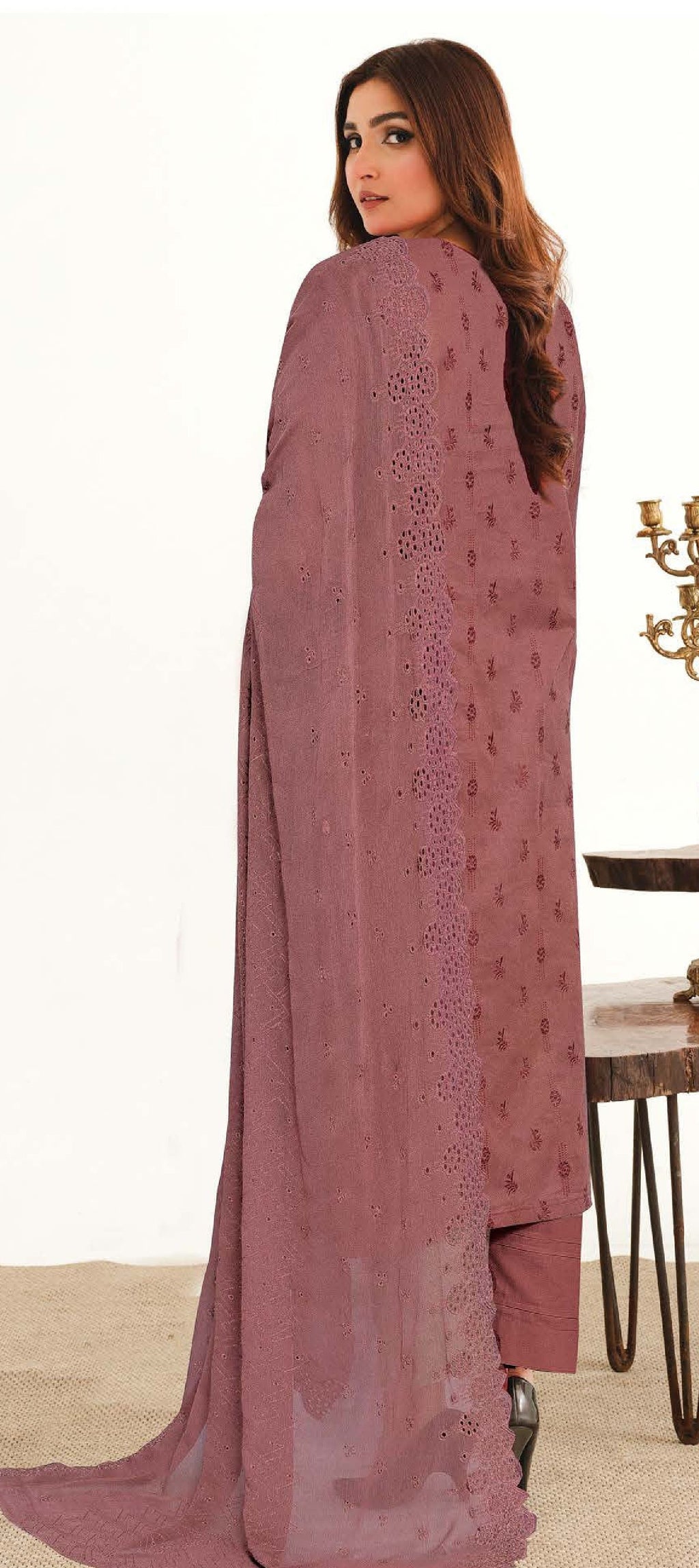 A woman wearing a traditional  three-piece suit with Chikankari 