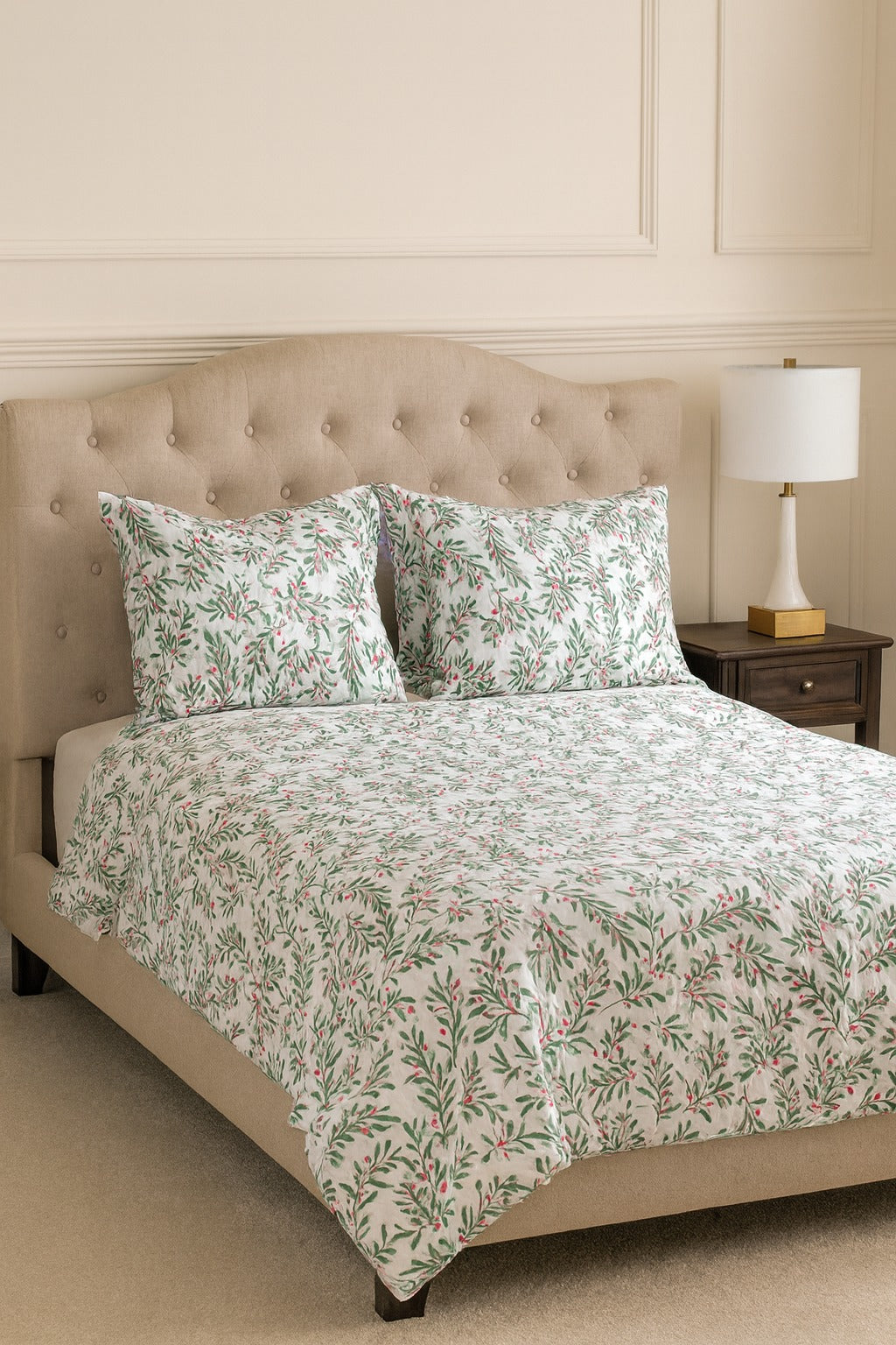 Bed with floral bedding and matching pillows in a bedroom setting.