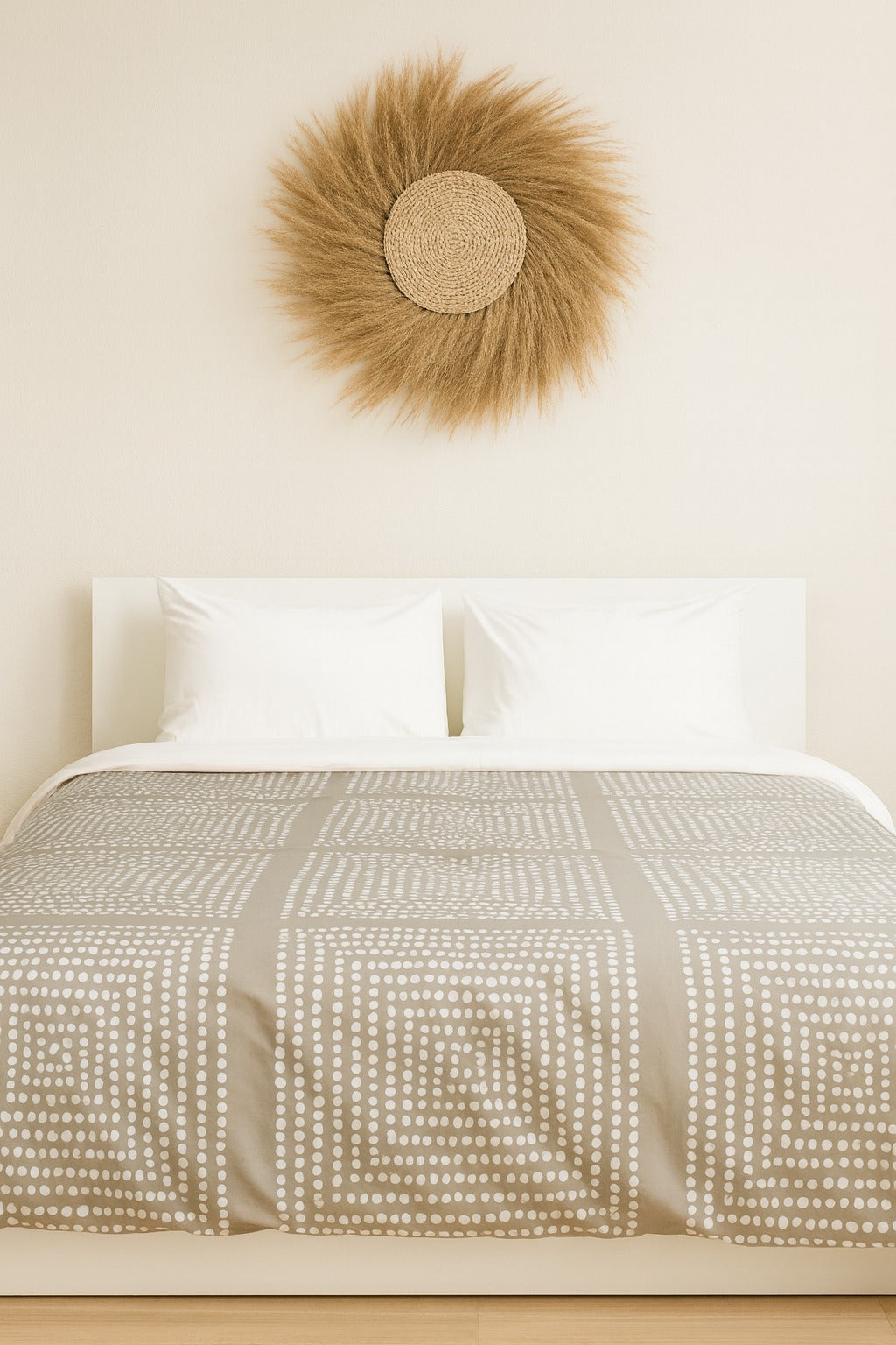 Bed with patterned duvet and decorative wall art in a bedroom setting