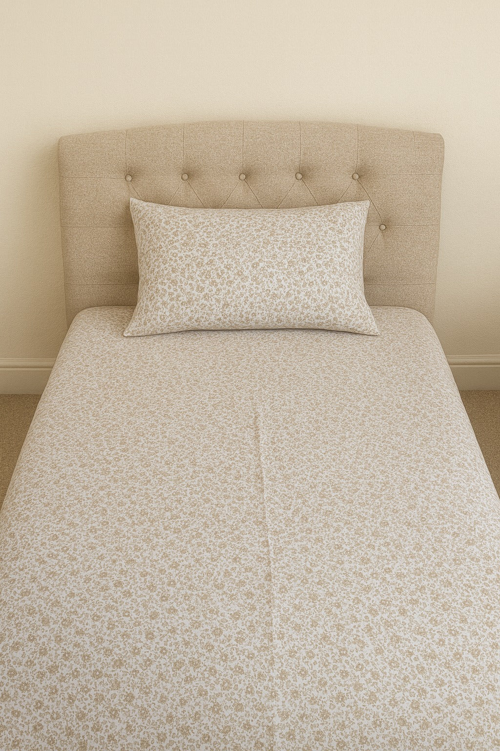 Beige floral-patterned bedsheet on a bed with a matching headboard.