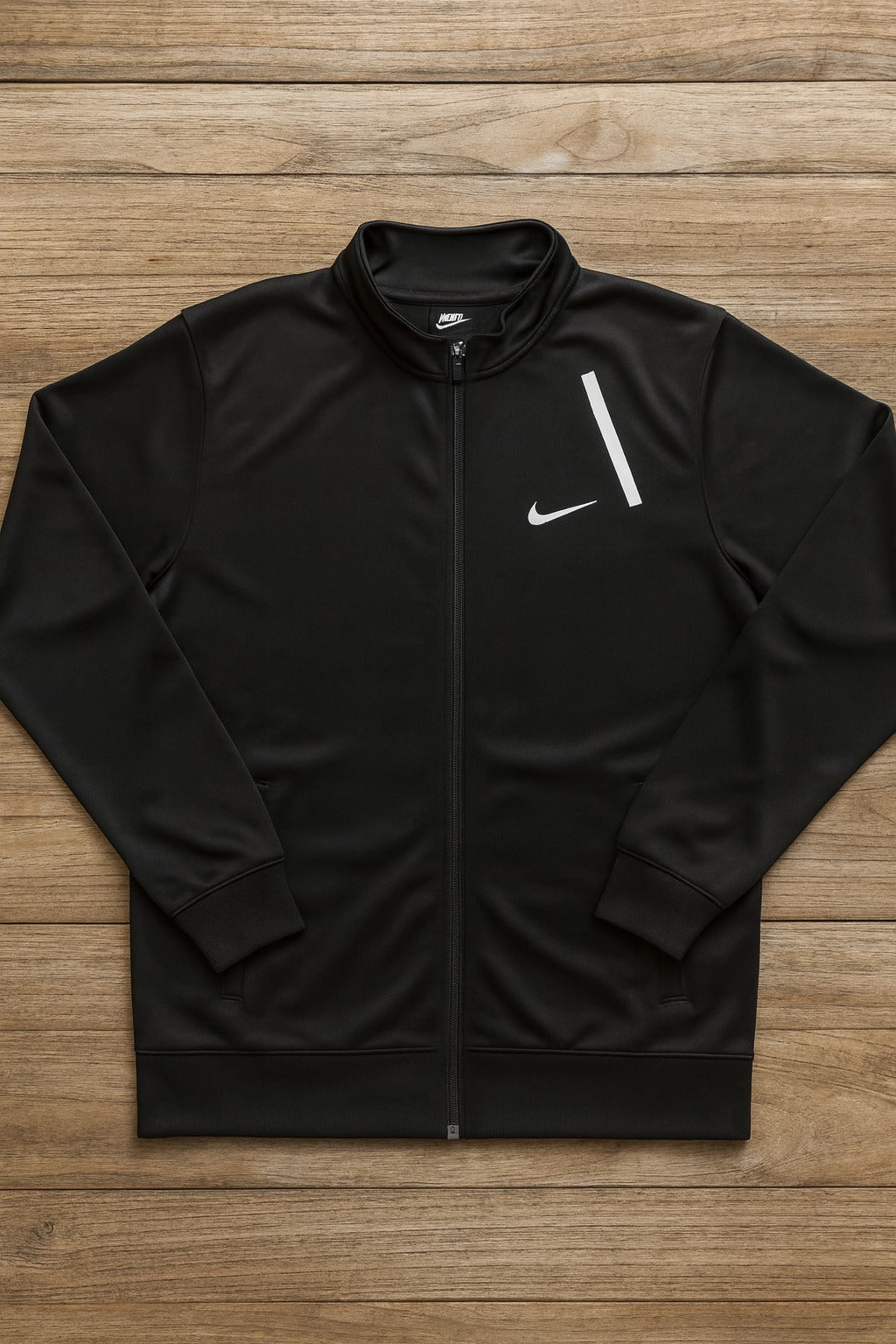Black Nike jacket on a wooden surface