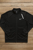 Black Nike jacket on a wooden surface