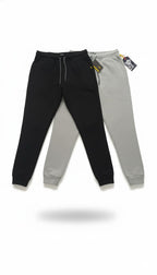 Black and gray jogger pants with tags on a white background