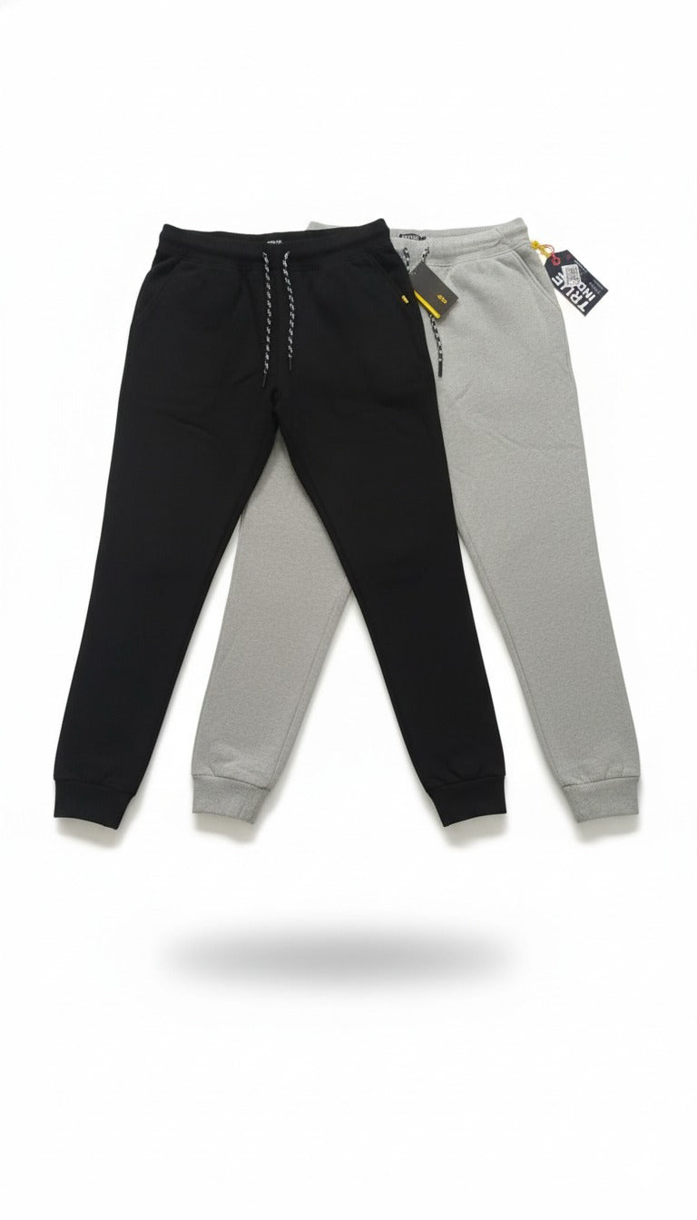 Black and gray jogger pants with tags on a white background