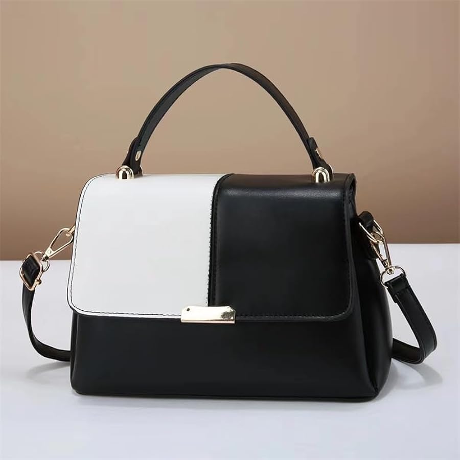 Black and white handbag with gold accents on a beige background