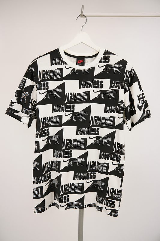 Black and white t-shirt with brand logos on a hanger against a white background