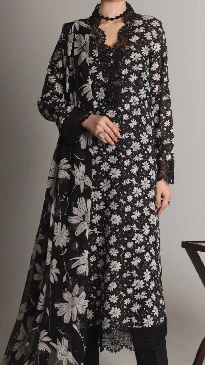 Black floral dress with long sleeves on a plain background