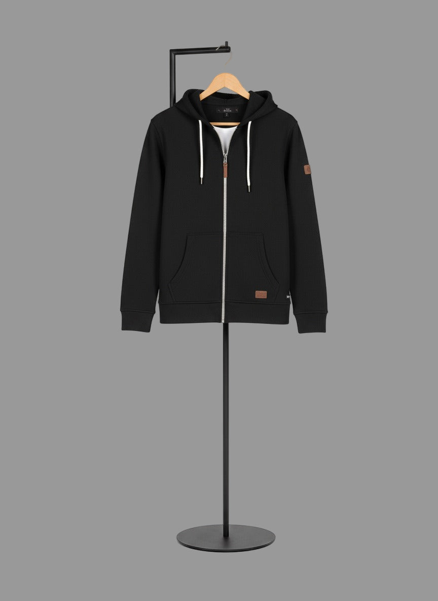 Black hoodie on a mannequin against a gray background