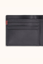 Black leather wallet with a red label on a white background