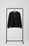 Black sweatshirt on a black rack against a white background