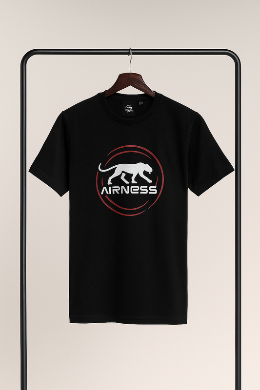 Black t-shirt with a logo on a hanger against a beige background