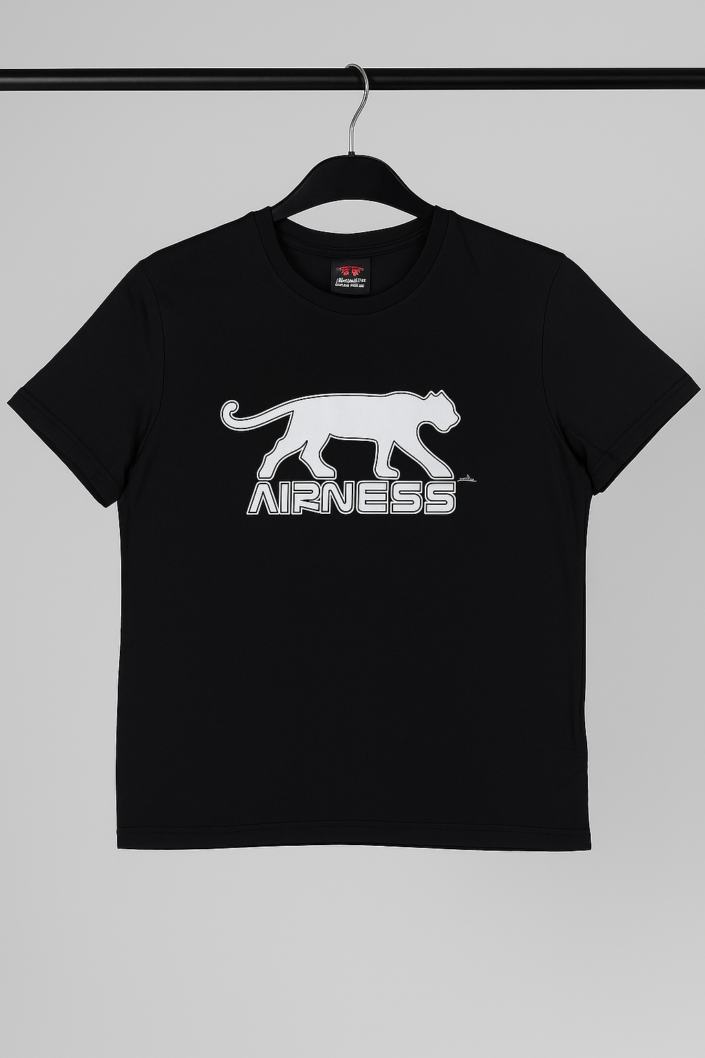 Black t-shirt with white logo on a hanger against a gray background