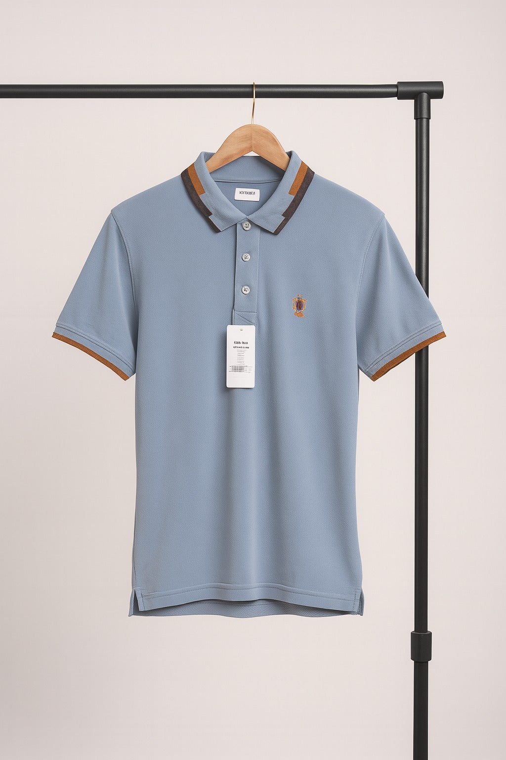 Blue polo shirt with brown accents on a hanger against a plain background