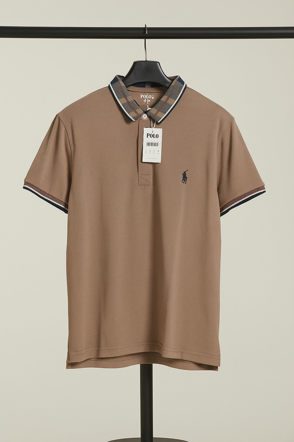 Brown Polo shirt with a tag on a hanger against a beige background