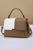 Brown and white handbag on a beige background