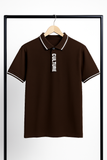 Brown polo shirt with 'CULTURE' text on a hanger against a white background