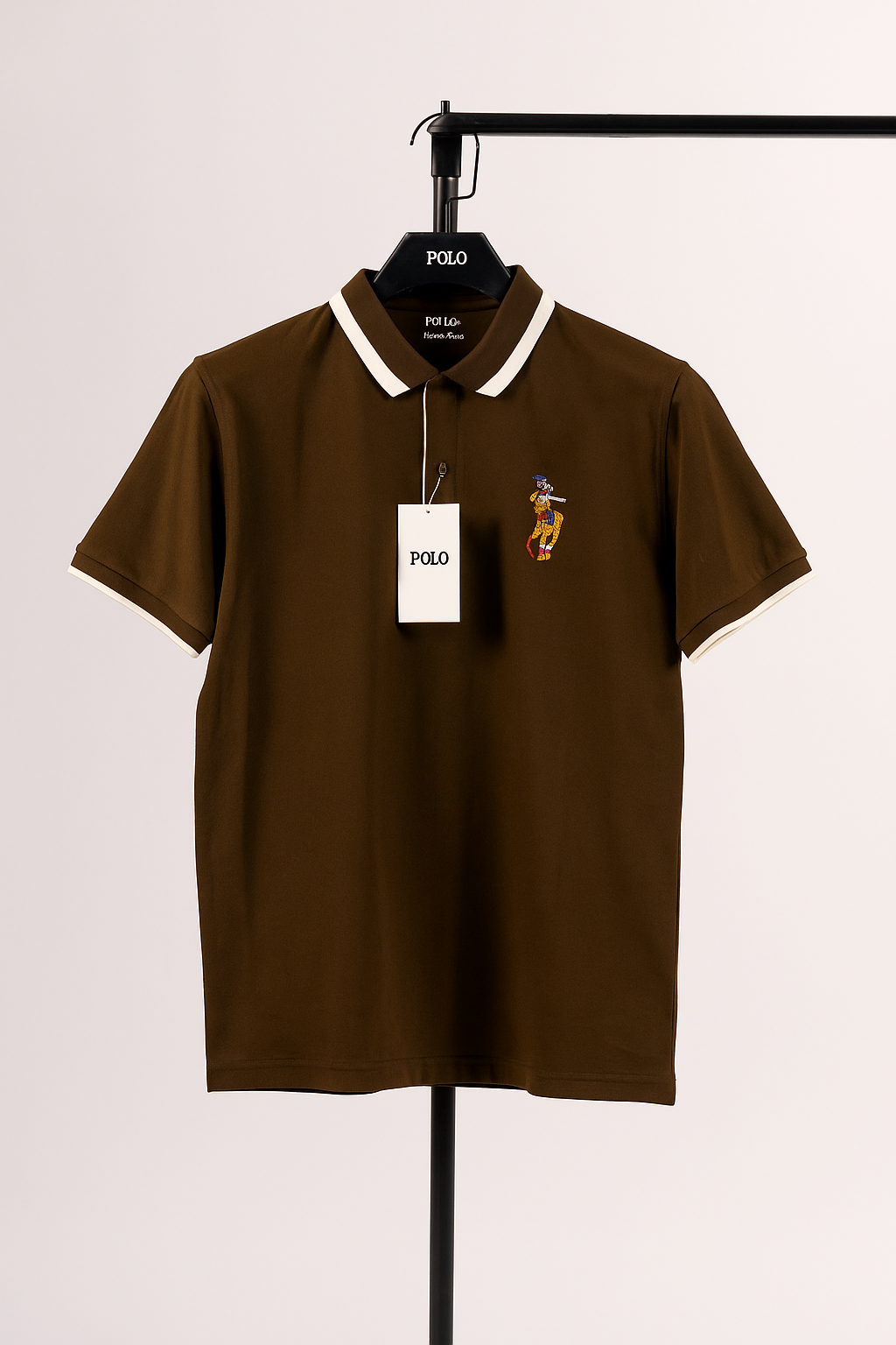 Brown polo shirt with a brand tag on a hanger against a white background