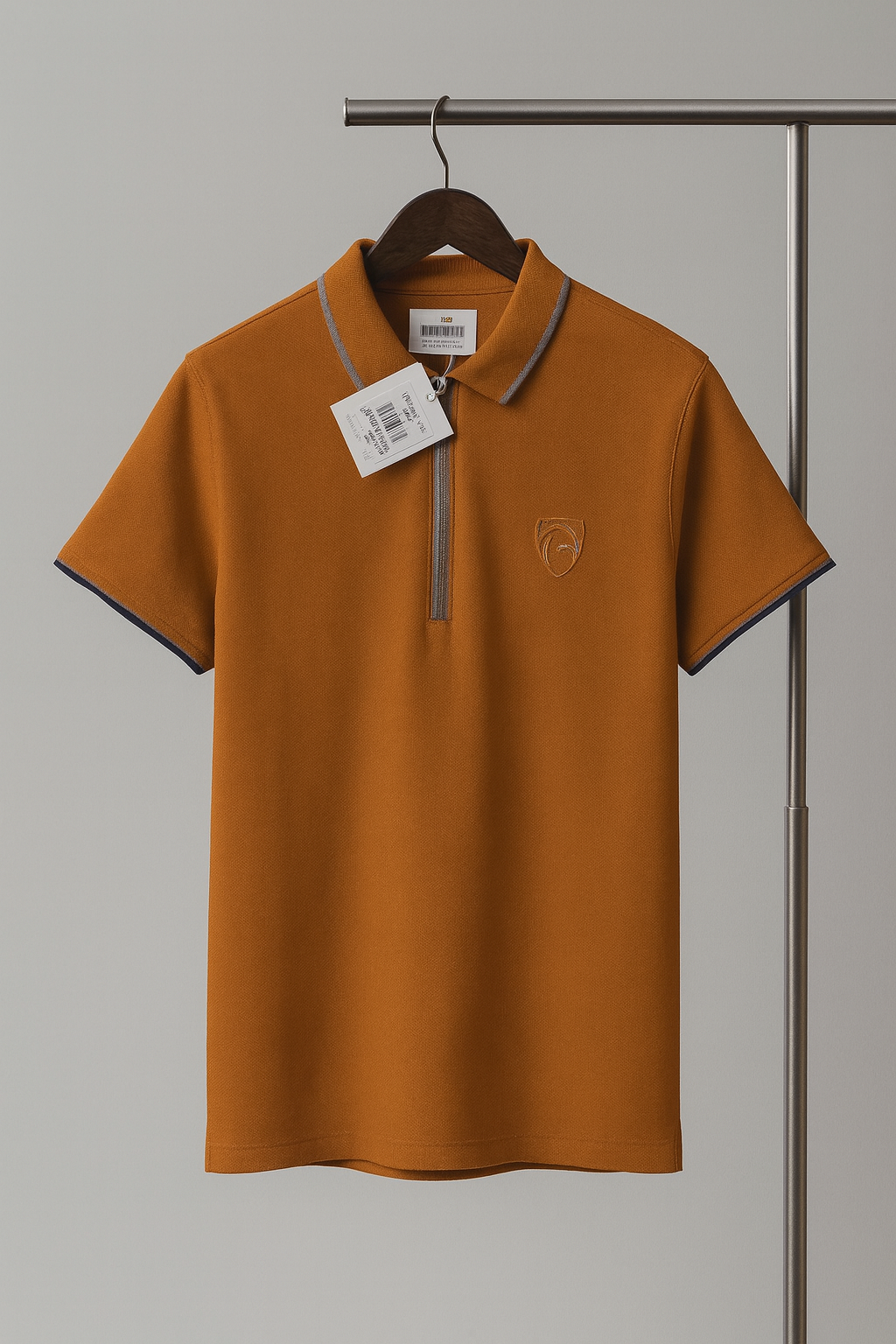 Brown polo shirt with a tag on a hanger against a gray background