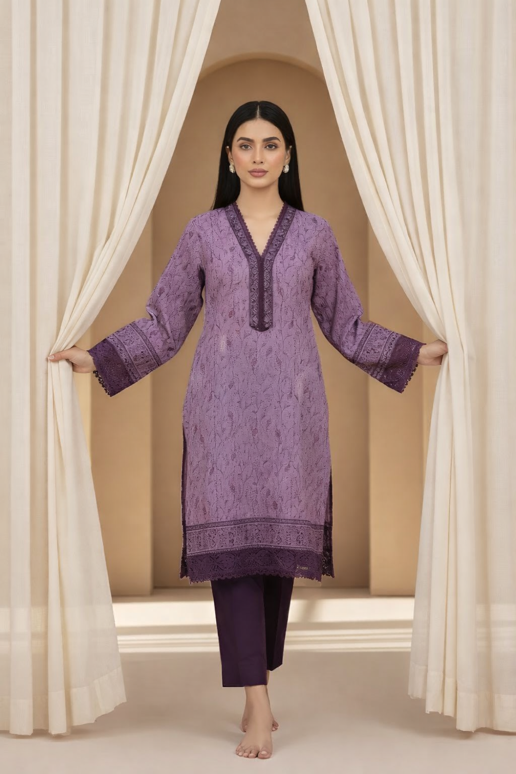 Woman wearing a purple traditional outfit standing between white curtains.