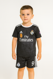 Child wearing a black sports jersey with visible branding on a white background