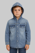 Child wearing a denim jacket with a hood on a gray background