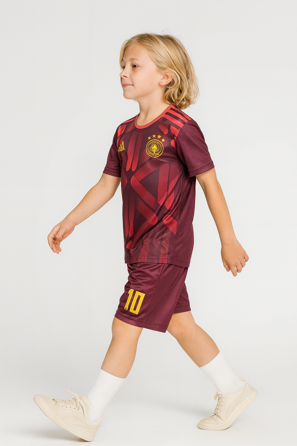 Child wearing a maroon sports outfit with yellow accents on a white background