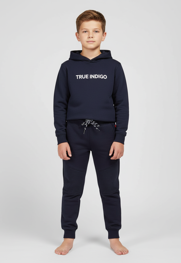 Child wearing a navy hoodie and jogger set with 'True Indigo' branding on a white background