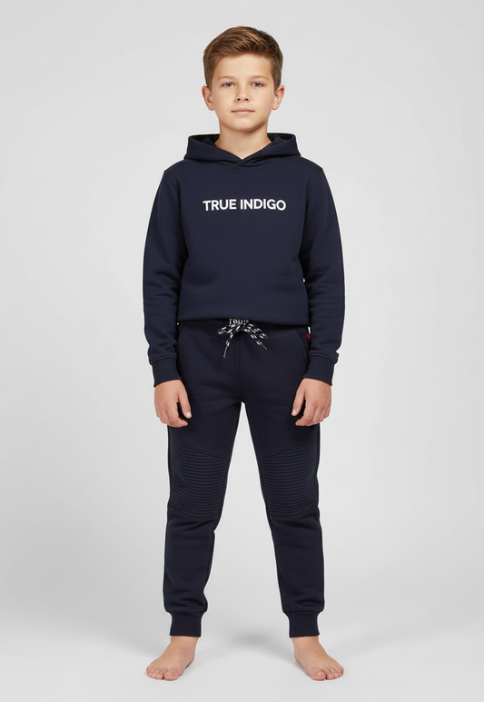 Child wearing a navy hoodie and jogger set with 'True Indigo' branding on a white background