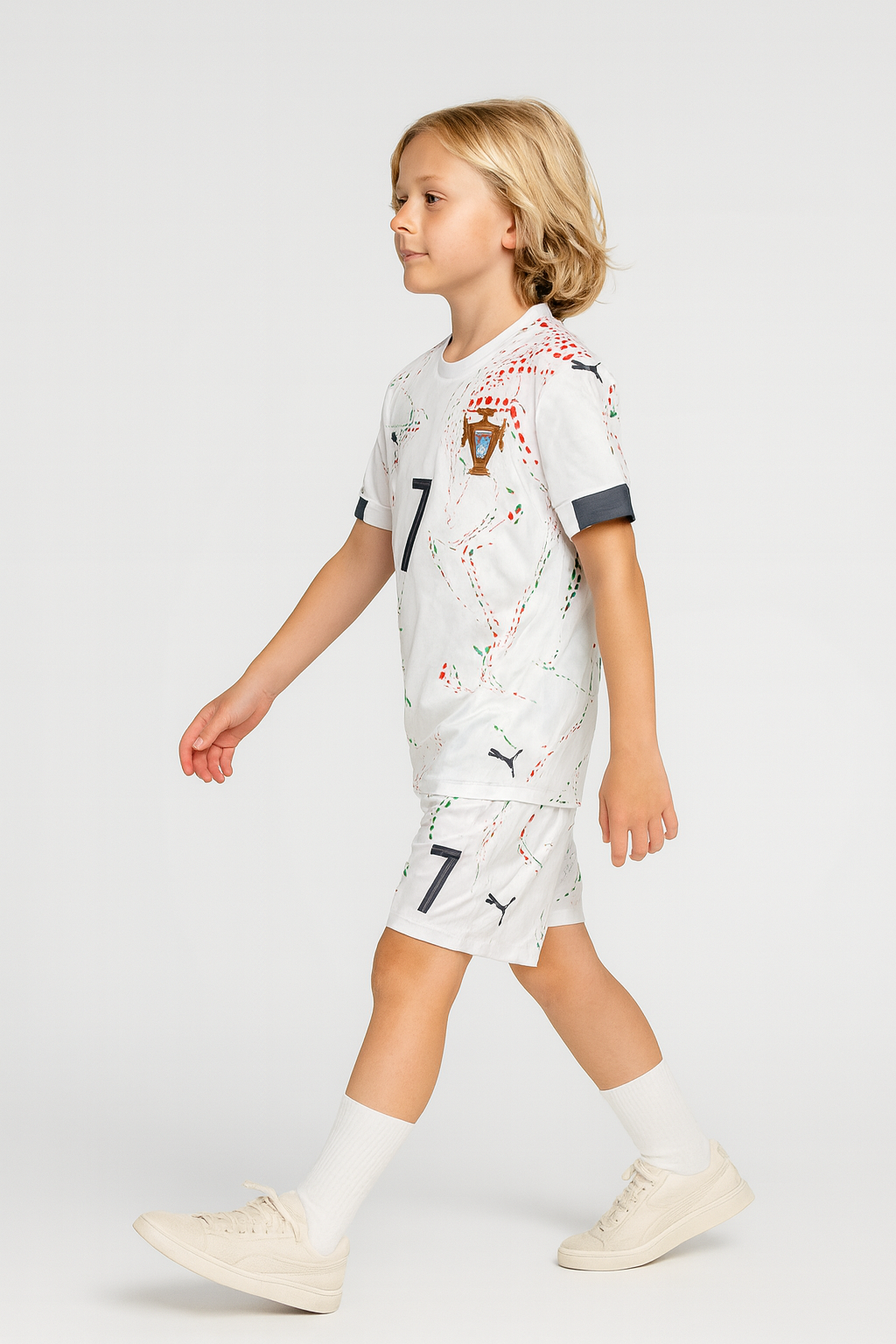 Child wearing a white sports outfit with black accents on a light gray background