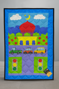 Children's prayermet with colorful design of a red building, cars, and traffic lights on a blue background.