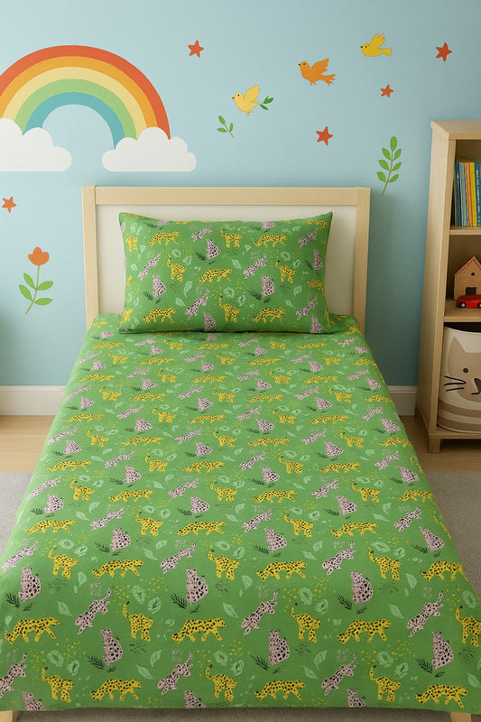 Children's room with green bedding featuring animal patterns, a rainbow, and colorful wall decals.