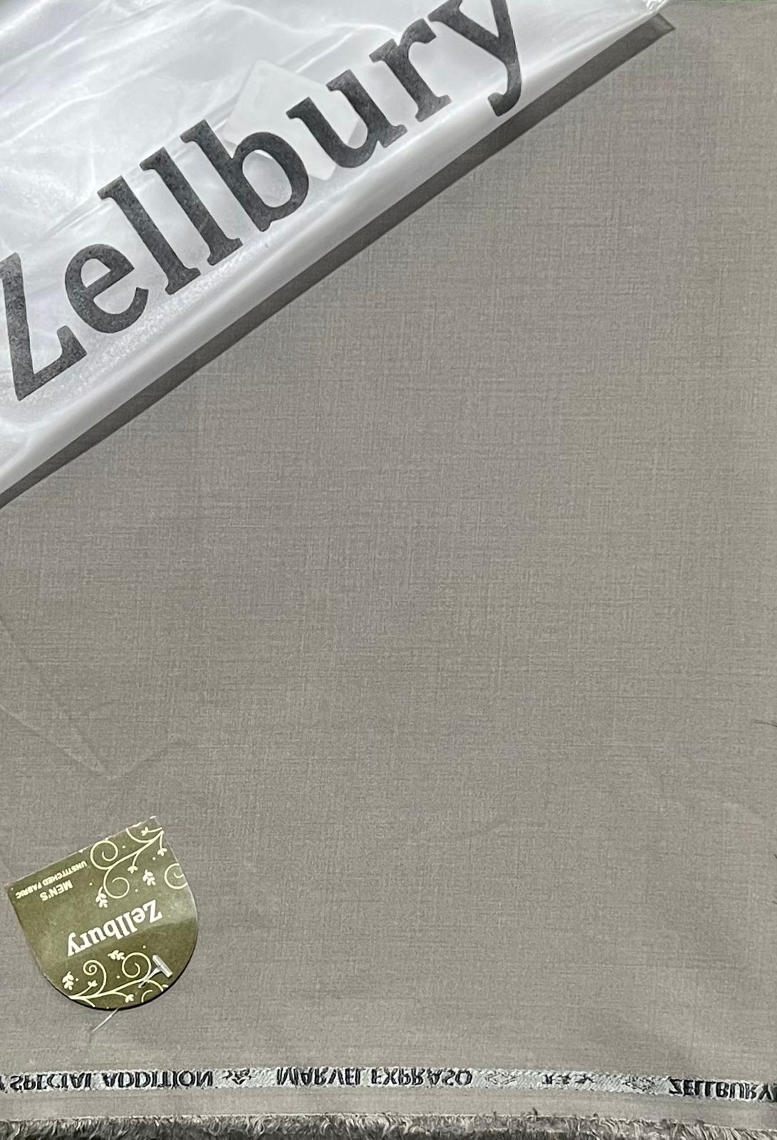 Close-up of a Zellbury product with a gold tag on a gray background