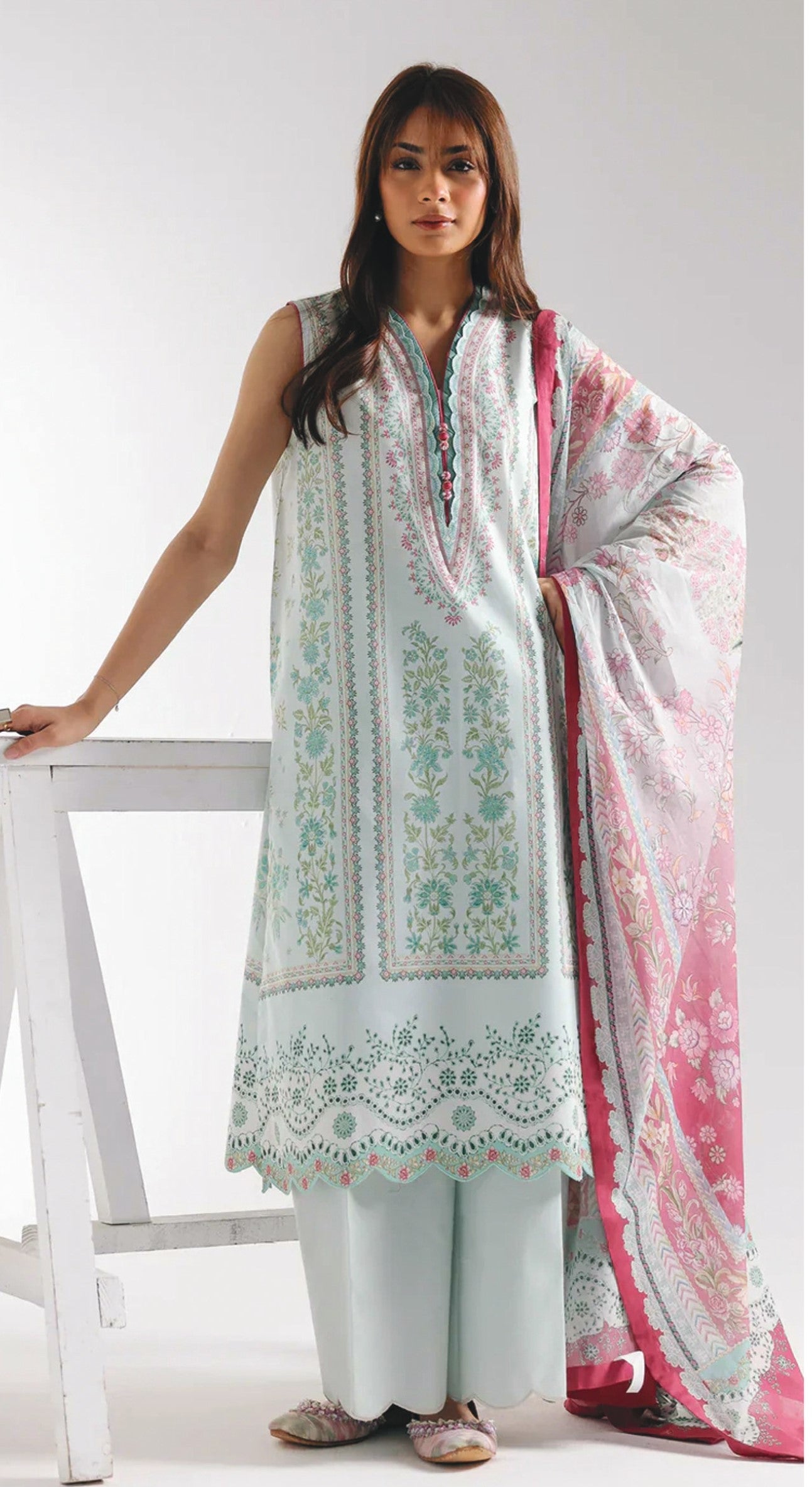 Woman wearing a light blue dress with  pink dupatta on a white background