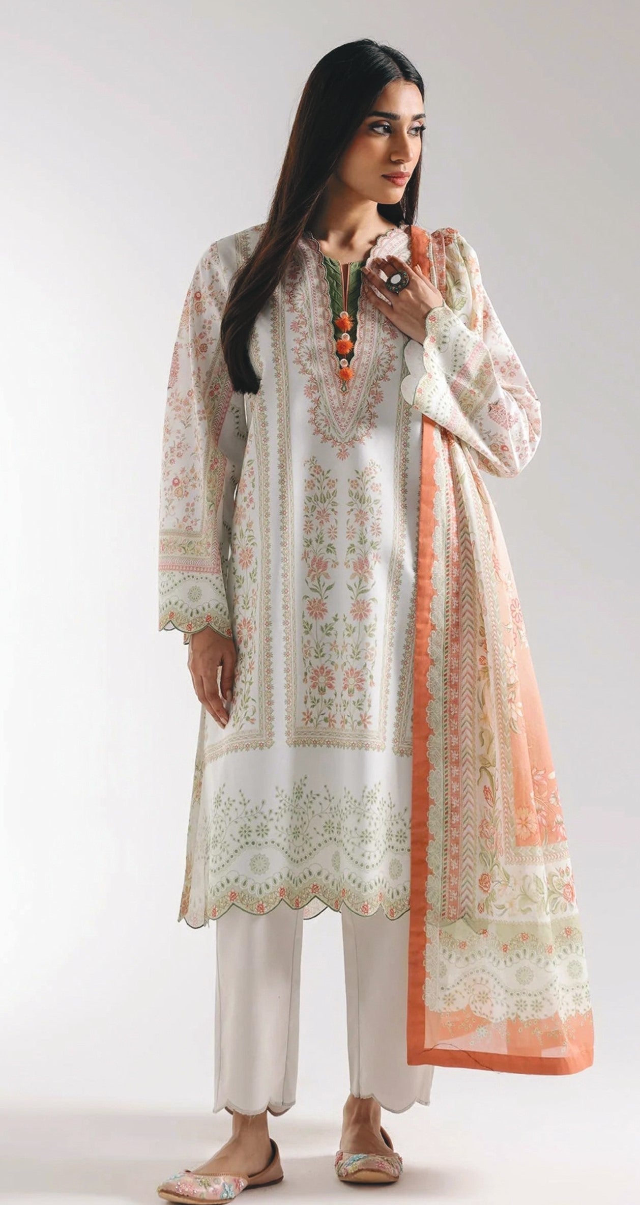 Woman wearing a traditional outfit with a floral pattern on a white background