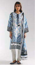 Woman wearing a blue and white patterned kurta with white pants on a white background