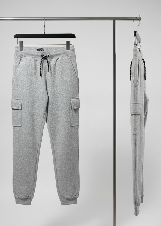 Gray jogger pants hanging on a rack against a white background