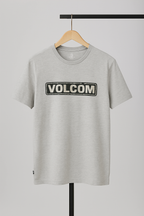 Gray t-shirt with Volcom logo on a hanger against a gray background